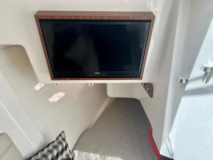  Yacht Photos Pics 2020 Pursuit DC 365 Dual Console interior with mounted TV and cozy seating area.
