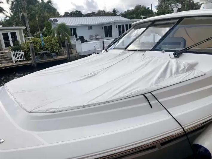  Yacht Photos Pics 2020 Pursuit DC 365 Dual Console boat docked near waterfront homes.