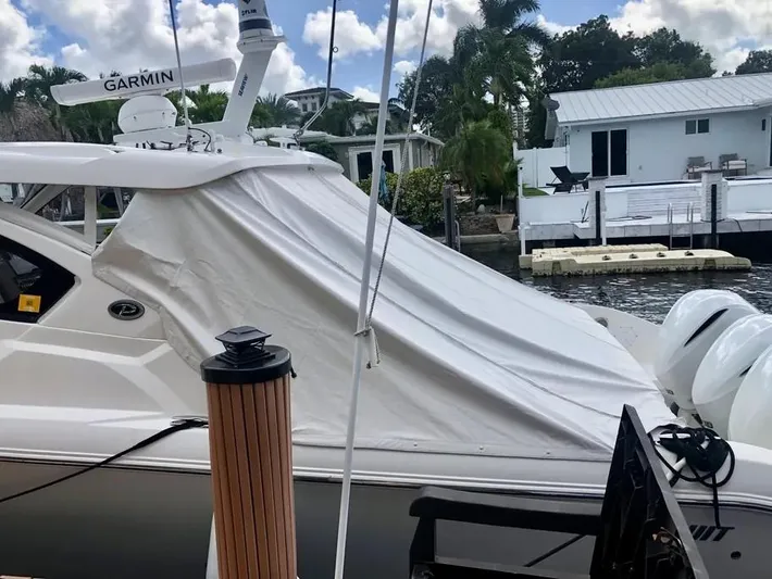  Yacht Photos Pics 2020 Pursuit DC 365 Dual Console boat docked with cover, Garmin radar visible.