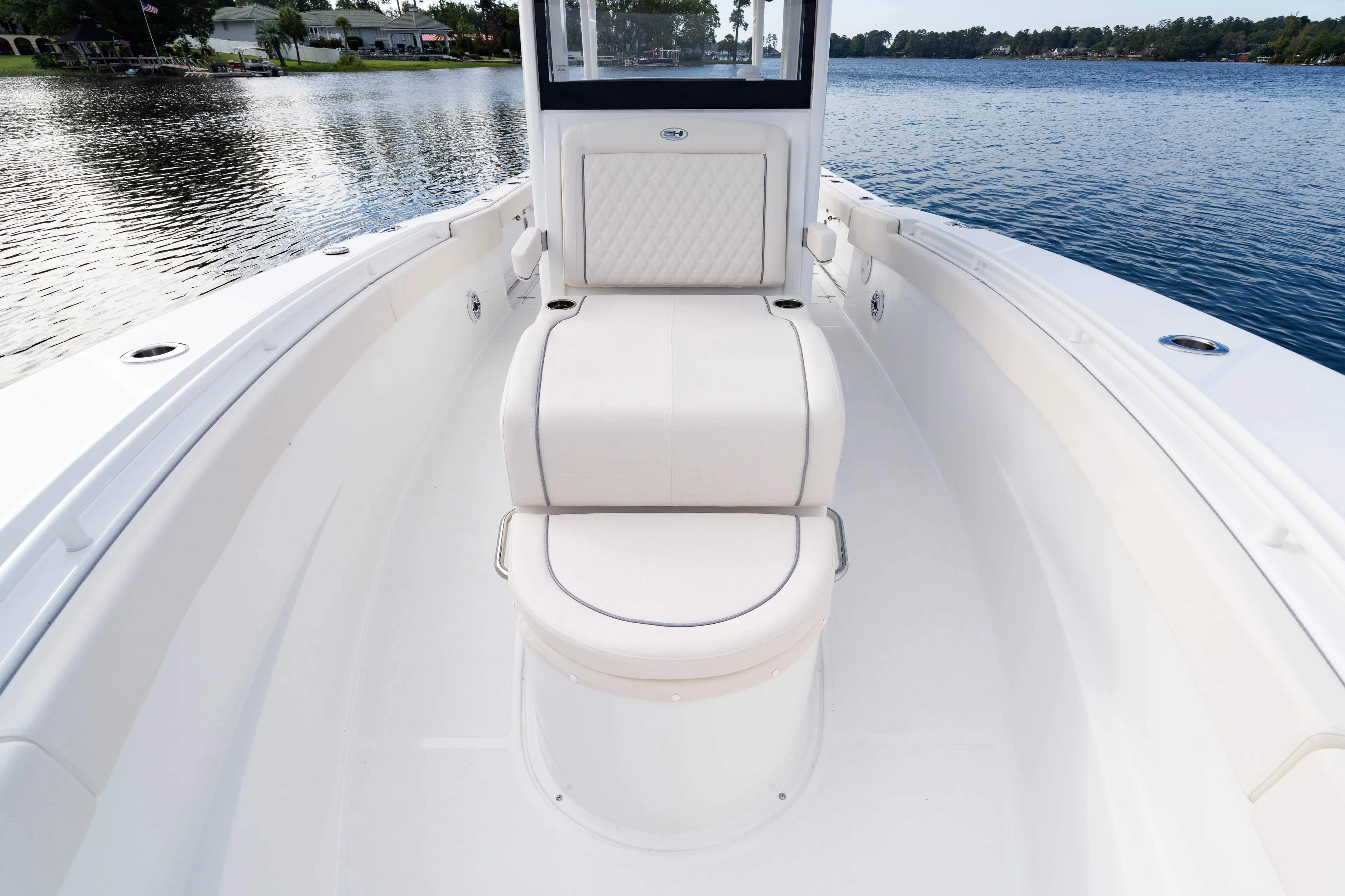  Yacht Photos Pics 2026 Sea Hunt Ultra 285 Coffin Box boat interior on a serene lake.