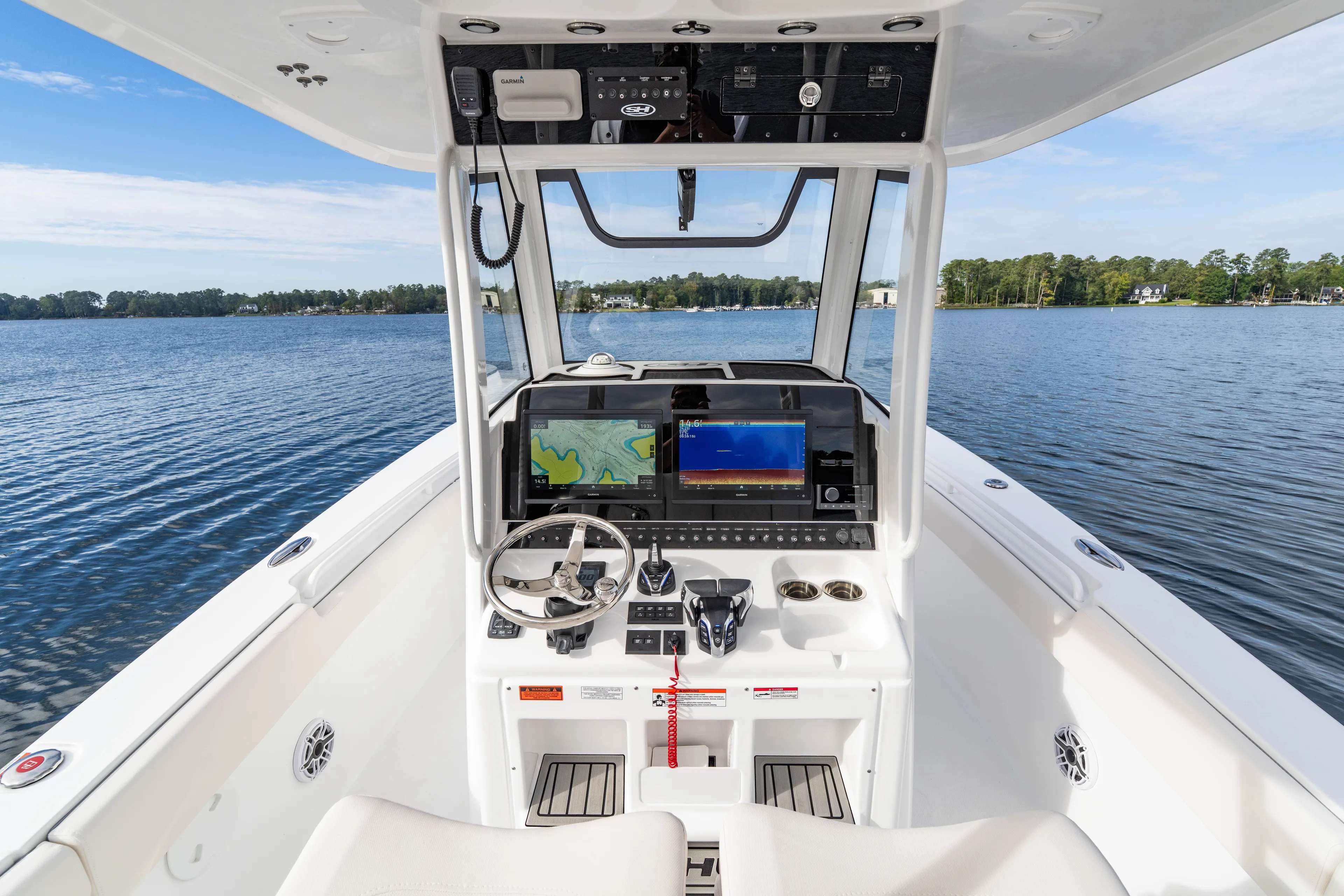  Yacht Photos Pics 2026 Sea Hunt Ultra 285 Coffin Box boat dashboard with navigation screens on a serene lake.