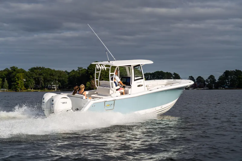  Yacht Photos Pics 2026 Sea Hunt Ultra 285 Coffin Box boat cruising on a lake under cloudy skies.