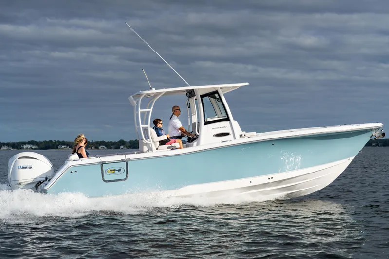  Yacht Photos Pics 2026 Sea Hunt Ultra 285 Coffin Box boat cruising on water under cloudy sky.