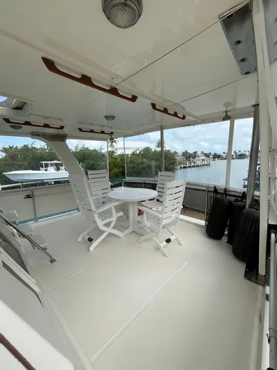 Soca Yacht Photos Pics 1988 Offshore Yachts Yachtfisher deck with seating, overlooking serene waterfront views.