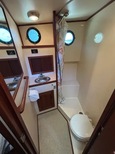 Forget Me Knot Yacht Photos Pics Bathroom interior of a 2001 Nordic Tug 32, featuring sink, toilet, and shower.