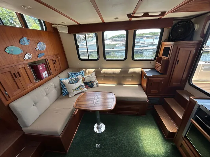 Forget Me Knot Yacht Photos Pics Cozy interior of 2001 Nordic Tug 32 with plush seating and nautical decor.