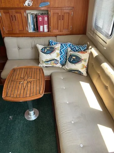 Forget Me Knot Yacht Photos Pics Interior of 2001 Nordic Tug 32 with cozy seating and decorative pillows.