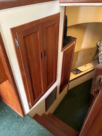 Forget Me Knot Yacht Photos Pics Interior of a 2001 Nordic Tug 32, featuring wooden cabinetry and cozy seating area.