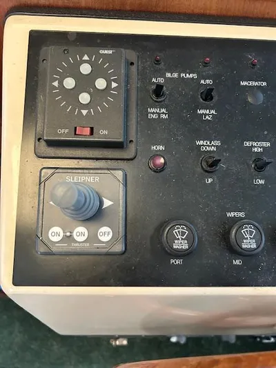 Forget Me Knot Yacht Photos Pics Control panel of a 2001 Nordic Tug 32 boat with various switches and buttons.