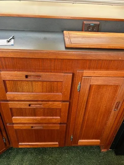 Forget Me Knot Yacht Photos Pics Wooden cabinetry inside a 2001 Nordic Tug 32, featuring drawers and a countertop.