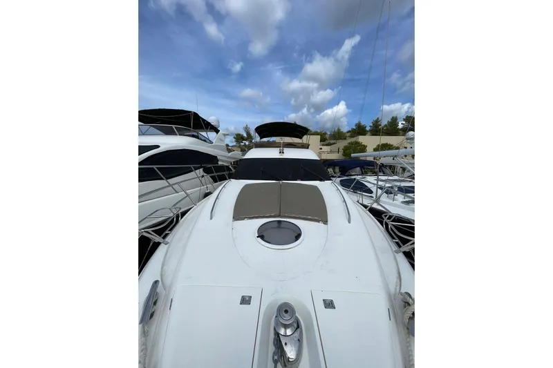  Yacht Photos Pics 2006 Princess 50 yacht docked under a partly cloudy sky.