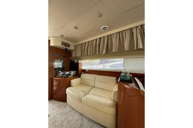  Yacht Photos Pics Interior of 2006 Princess 50 yacht with beige sofa and wooden cabinetry.