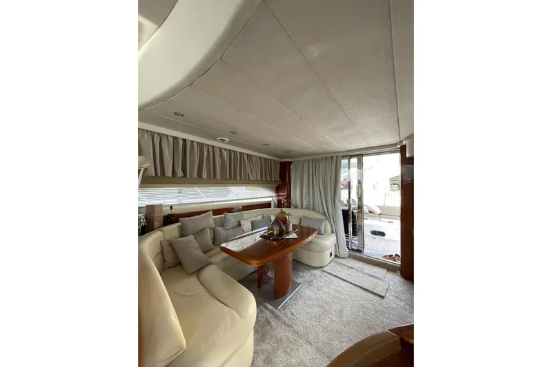  Yacht Photos Pics Luxurious interior of a 2006 Princess 50 yacht with elegant seating and dining area.