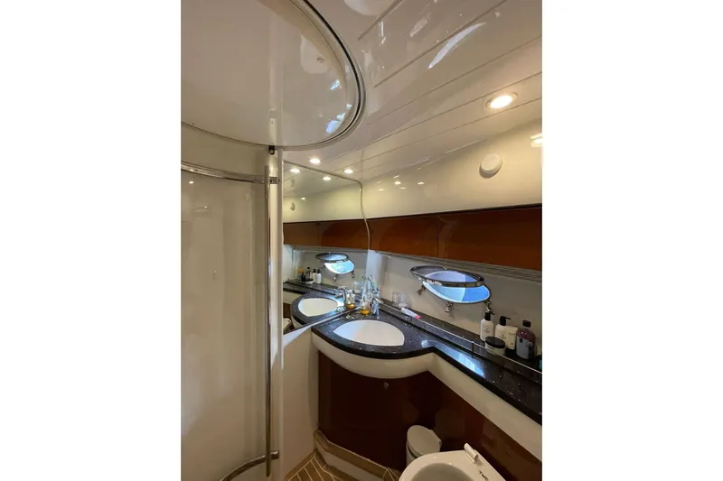 Yacht Photos Pics Luxurious bathroom interior of 2006 Princess 50 yacht with modern fixtures and elegant design.