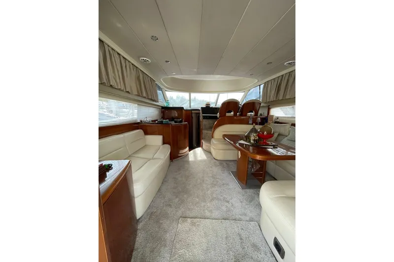  Yacht Photos Pics Luxurious interior of a 2006 Princess 50 yacht with elegant seating and wooden accents.