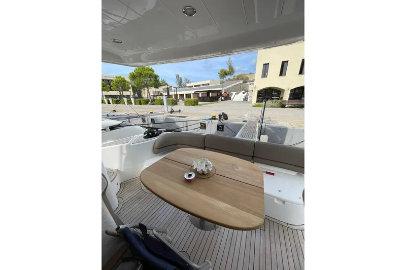  Yacht Photos Pics Luxurious 2006 Princess 50 yacht interior with elegant wooden table and seating area.