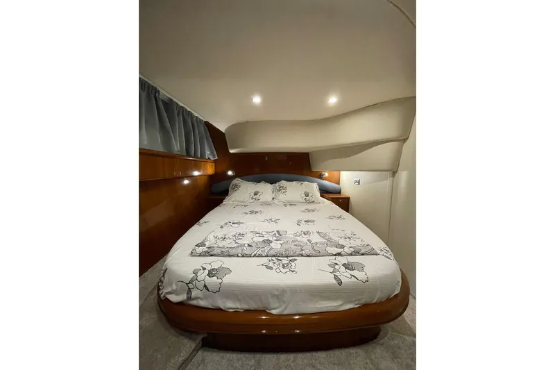  Yacht Photos Pics Luxurious bedroom interior of 2006 Princess 50 yacht with elegant bedding.