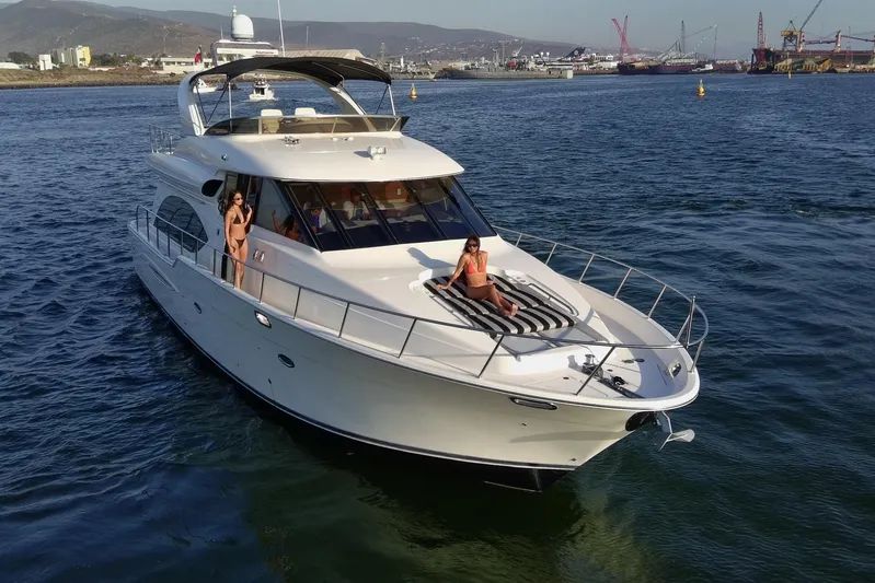 Seas The Day Yacht Photos Pics 2004 Meridian 580 Pilothouse yacht cruising with passengers in a scenic harbor setting.