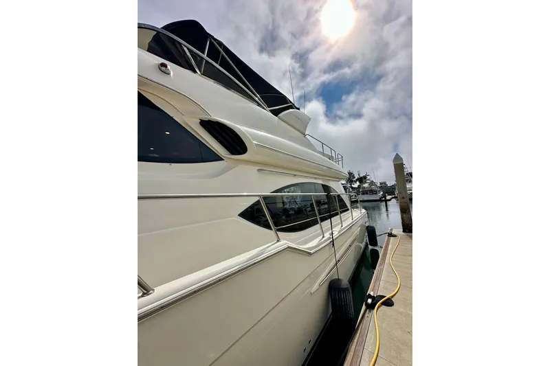 Seas The Day Yacht Photos Pics 2004 Meridian 580 Pilothouse yacht docked under a cloudy sky.