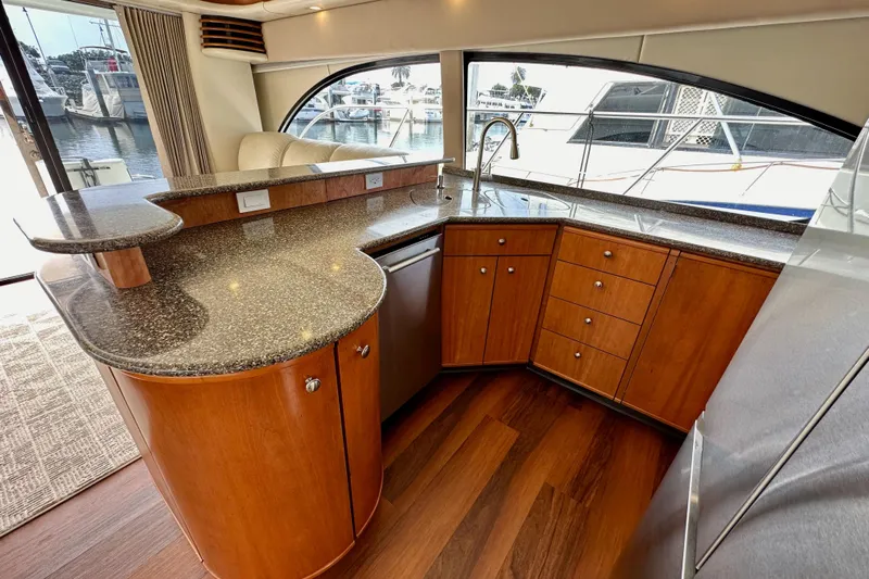 Seas The Day Yacht Photos Pics Luxurious 2004 Meridian 580 Pilothouse yacht interior with modern kitchen and elegant wood cabinetry.