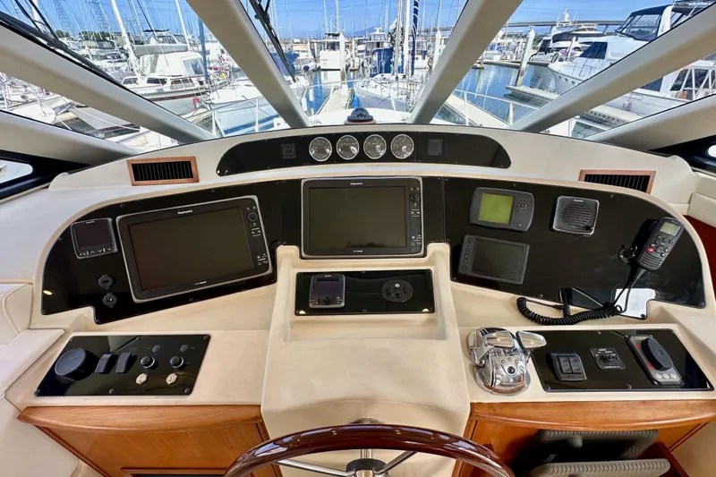 Seas The Day Yacht Photos Pics Pilothouse of 2004 Meridian 580 yacht with navigation equipment and marina view.