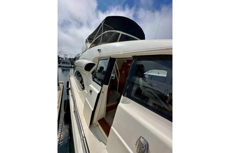 Seas The Day Yacht Photos Pics 2004 Meridian 580 Pilothouse yacht docked at marina under cloudy sky.