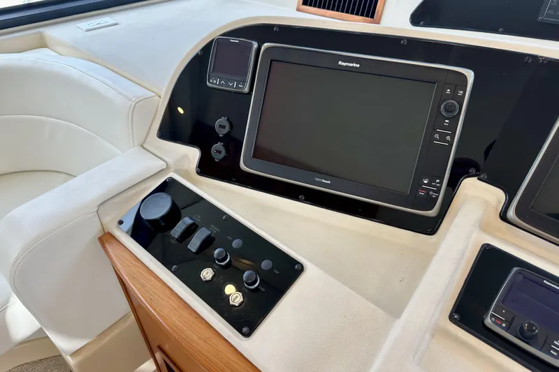 Seas The Day Yacht Photos Pics Control panel of a 2004 Meridian 580 Pilothouse yacht with navigation equipment.