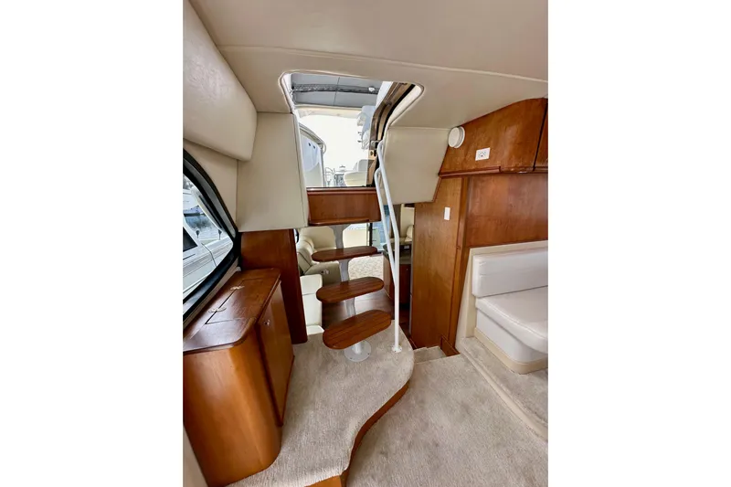 Seas The Day Yacht Photos Pics Interior of 2004 Meridian 580 Pilothouse yacht with wooden stairs and seating area.