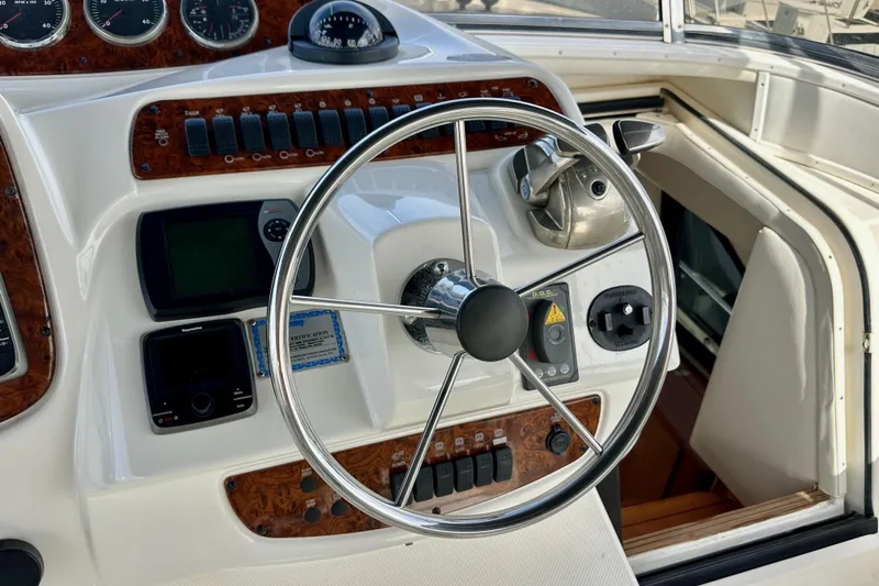 Seas The Day Yacht Photos Pics Steering wheel and controls of a 2004 Meridian 580 Pilothouse yacht.
