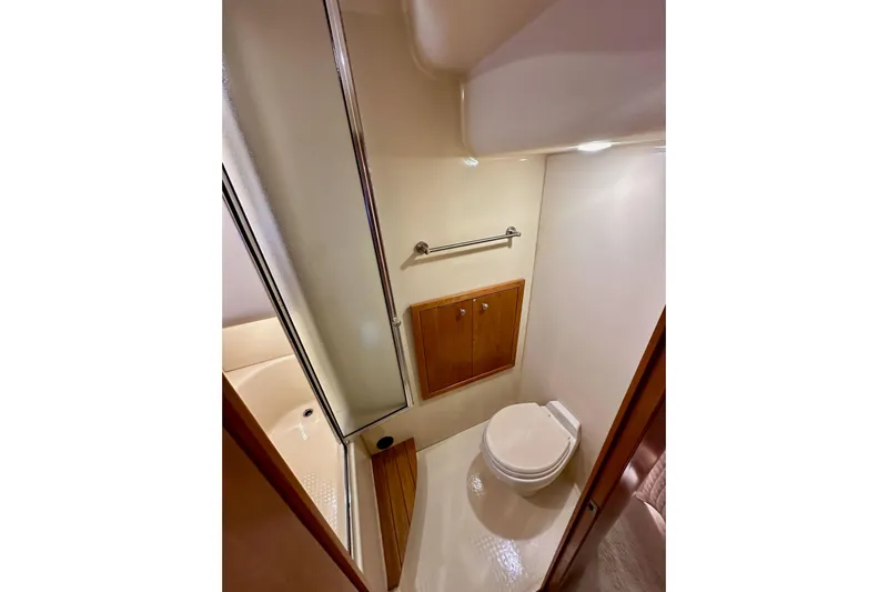 Seas The Day Yacht Photos Pics Bathroom interior of 2004 Meridian 580 Pilothouse yacht, featuring shower and toilet.