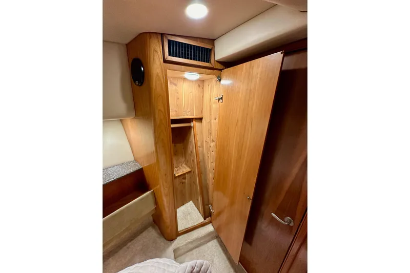 Seas The Day Yacht Photos Pics Wooden closet interior in 2004 Meridian 580 Pilothouse yacht cabin.