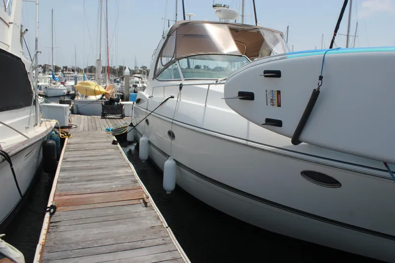 My Jojo Yacht Photos Pics 2005 Cruisers Yachts 370 Express docked with paddleboard attached, marina background.