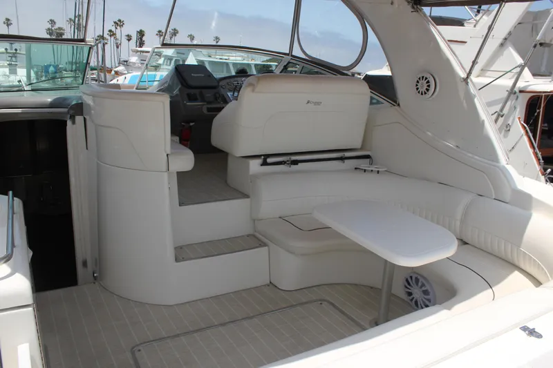 My Jojo Yacht Photos Pics 2005 Cruisers Yachts 370 Express interior with white seating and table, docked at marina.