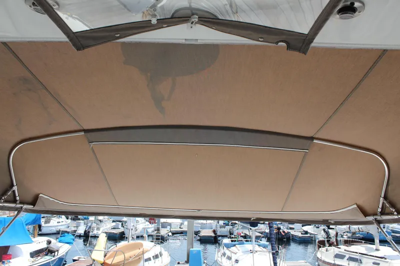 My Jojo Yacht Photos Pics 2005 Cruisers Yachts 370 Express canopy with marina view in background.