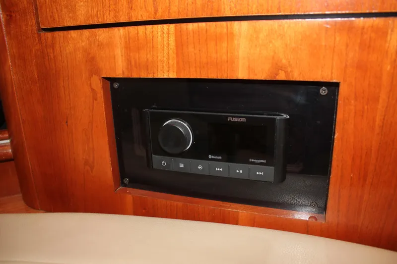 My Jojo Yacht Photos Pics Fusion stereo system in 2005 Cruisers Yachts 370 Express, mounted on wooden panel.