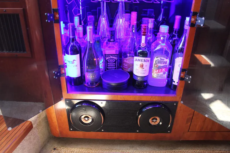 My Jojo Yacht Photos Pics Bar cabinet with assorted liquor bottles and speakers on a 2005 Cruisers Yachts 370 Express.