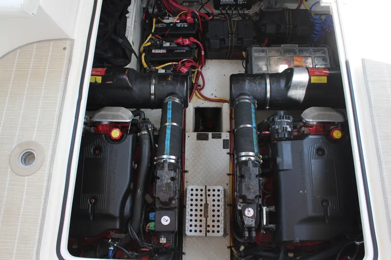 My Jojo Yacht Photos Pics Engine compartment of 2005 Cruisers Yachts 370 Express, featuring dual engines and battery setup.