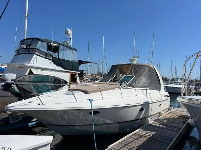 My Jojo Yacht Photos Pics 2005 Cruisers Yachts 370 Express docked at marina under clear blue sky.