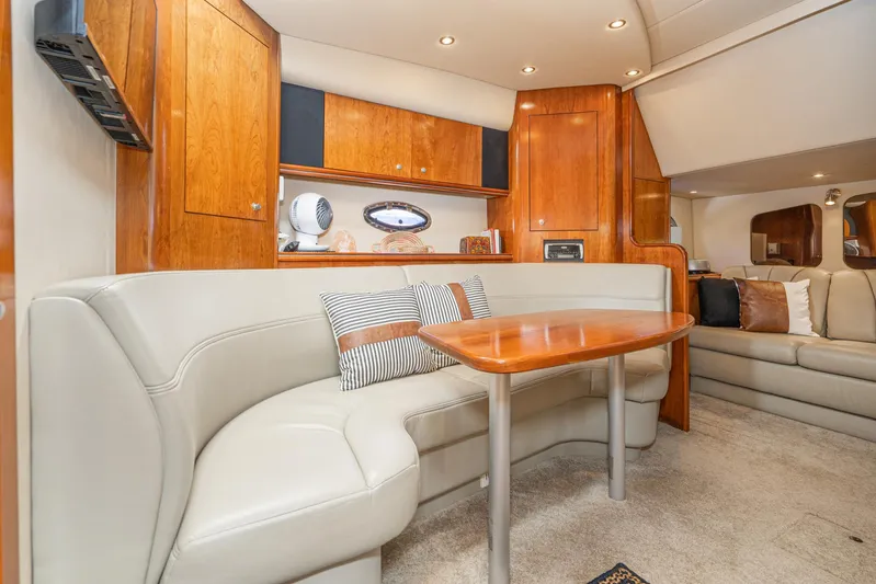 My Jojo Yacht Photos Pics Luxurious interior of 2005 Cruisers Yachts 370 Express with elegant seating and wooden cabinetry.