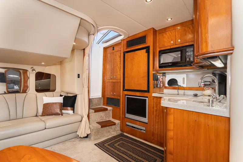 My Jojo Yacht Photos Pics Luxurious interior of 2005 Cruisers Yachts 370 Express with modern kitchen and cozy seating.