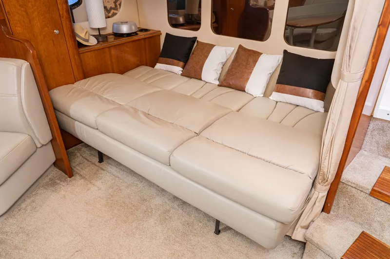My Jojo Yacht Photos Pics Luxurious interior of 2005 Cruisers Yachts 370 Express with beige leather seating and decorative pillows.