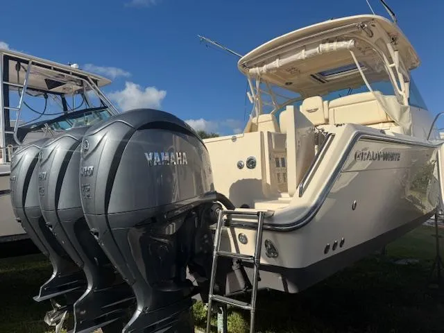  Yacht Photos Pics 2021 Grady-White Express 370 boat with Yamaha outboard engines, docked under clear skies.