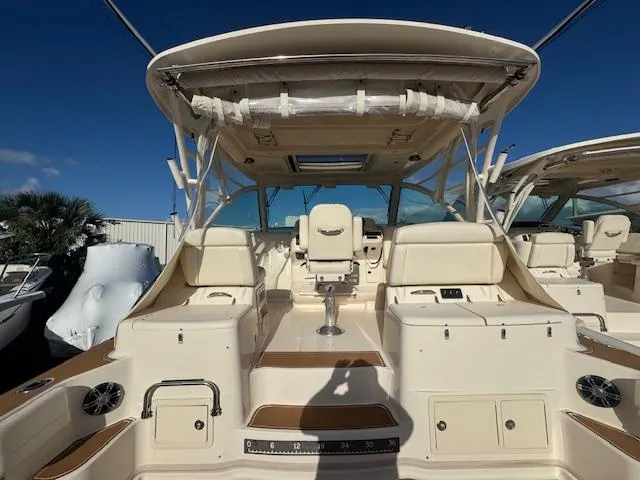  Yacht Photos Pics 2021 Grady-White Express 370 boat interior with seating and helm, under clear blue sky.