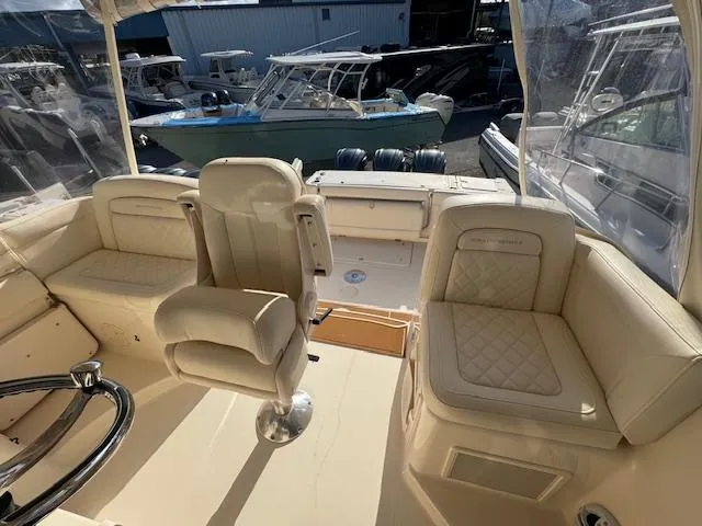  Yacht Photos Pics 2021 Grady-White Express 370 boat interior with beige seating and helm.