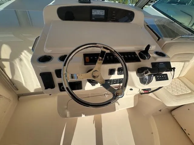  Yacht Photos Pics 2021 Grady-White Express 370 helm with steering wheel and control panel.