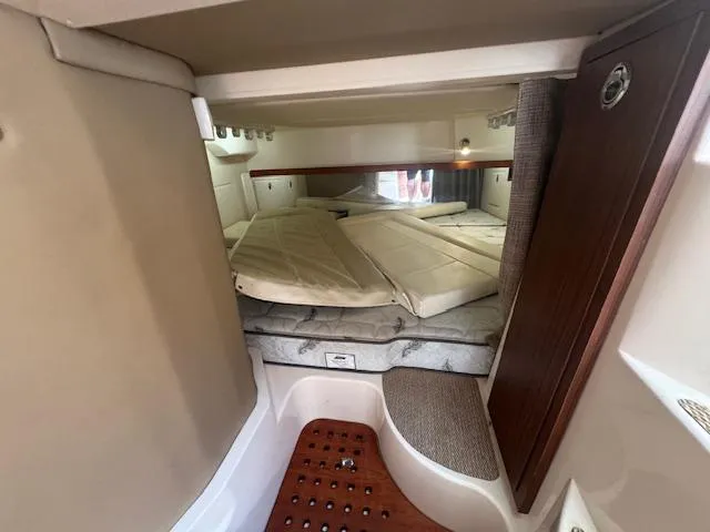  Yacht Photos Pics 2021 Grady-White Express 370 cabin interior with cozy sleeping area and wooden accents.