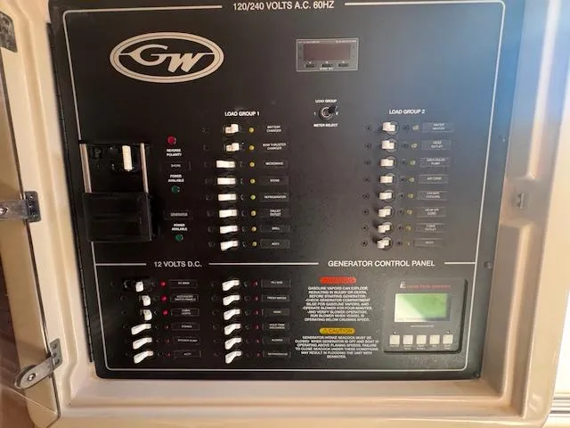  Yacht Photos Pics Grady-White Express 370 2021 electrical control panel with generator controls and circuit breakers.