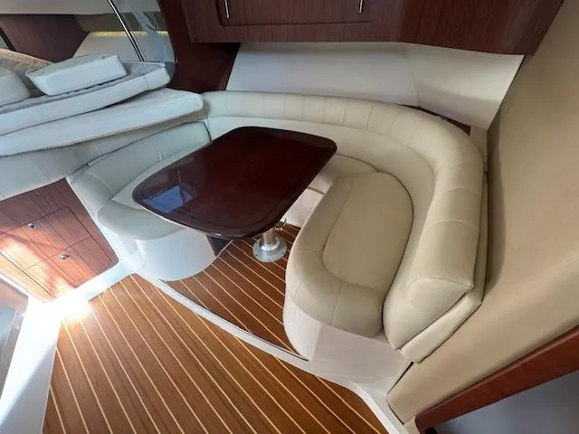  Yacht Photos Pics Luxurious interior of 2021 Grady-White Express 370 with elegant seating and wooden table.