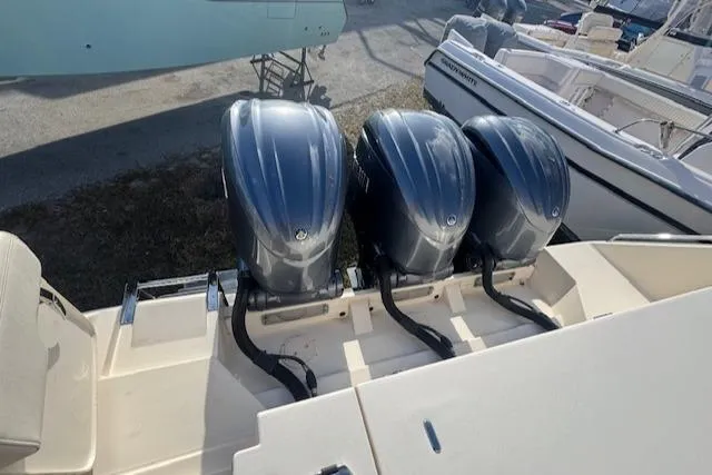  Yacht Photos Pics 2021 Grady-White Express 370 with triple outboard engines, docked at a marina.