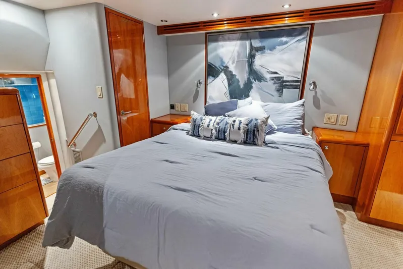 Big Game Yacht Photos Pics Luxurious bedroom interior of 2006 Hatteras 68 Convertible yacht with modern decor.